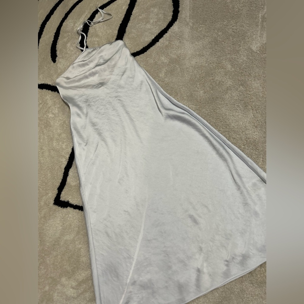 This is a midi slip dress with a halter neckline and bias-cut body